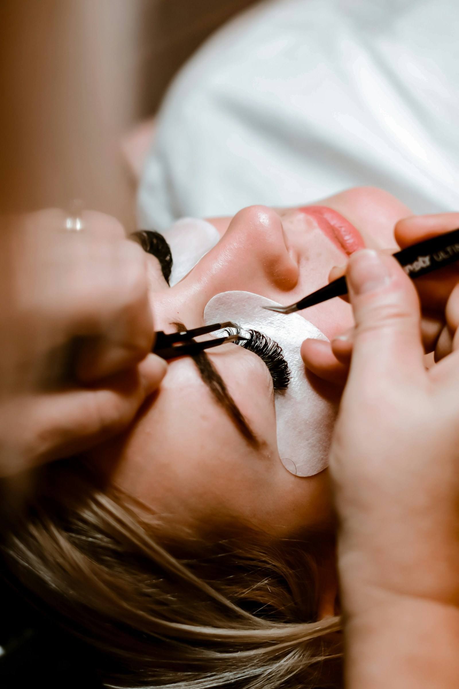 Wimpernextensions werden mit der Pinzette einzeln angesetzt